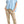 Load image into Gallery viewer, Woman wearing a light blue poncho and beige pants on a plain background