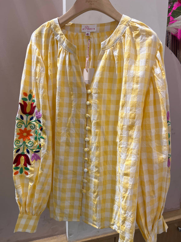 Checked tunic with floral embroidery on the sleeves
