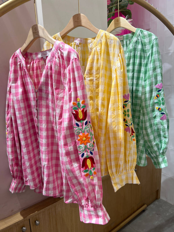 Checked tunic with floral embroidery on the sleeves
