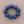 Load image into Gallery viewer, A beaded bracelet made of eight matte blue round beads, arranged in a circle on a neutral taupe background.
