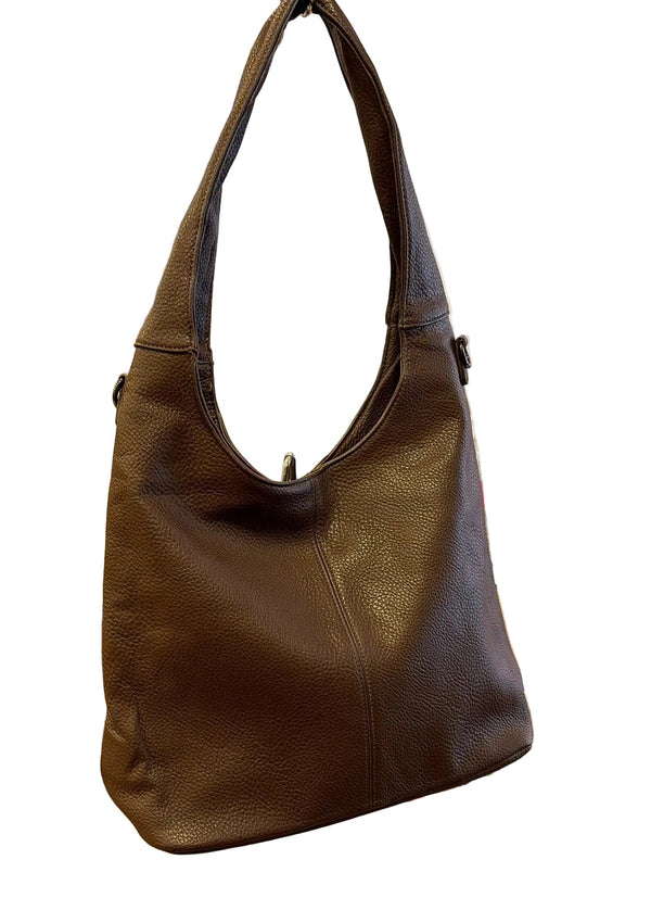 A dark brown pebbled leather hobo shoulder bag displayed on a metal stand on a wooden counter inside a retail store.