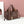 Load image into Gallery viewer, A brown pebbled leather tote bag with dual top handles, a detachable shoulder strap, and a small gold rectangular charm, displayed on a white surface against a pink wall with a white decorative prop.

