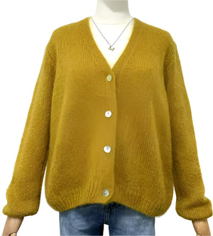 Mustard yellow mohair cardigan on a mannequin against a white background