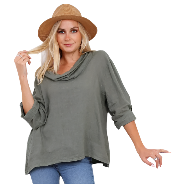 Woman wearing a khaki green  linen top with a cowl neck and straw hat