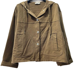 Brown jacket with a hood on a hanger against a light gray brick wall.