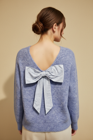 Blue sweater with a large bow on a V neck back