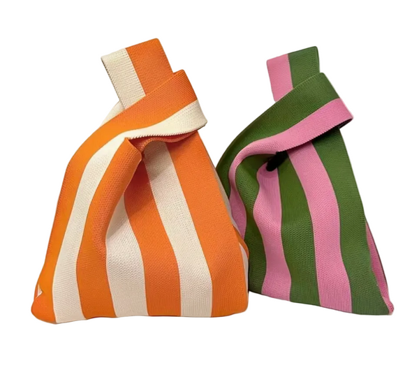 Two striped bags, one orange and white, the other green and pink, on a white background.