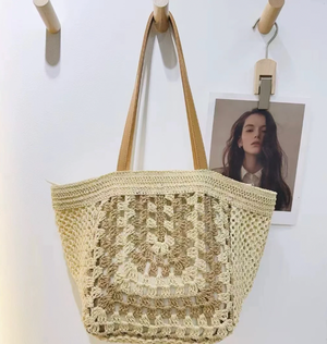 Beige crochet bag with a plain background