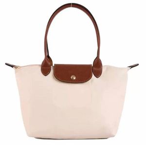 Beige handbag with brown leather handles and accents on a white background