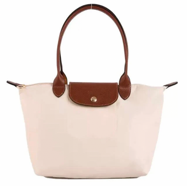 Beige handbag with brown leather handles and accents on a white background