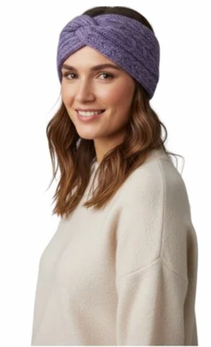 A woman wearing a textured purple twisted headband and a cream-colored knit sweater, shown from the chest up against a plain white background.