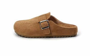 A single tan suede clog-style mule shoe with a silver buckle strap, shown from a side profile on a white background.
