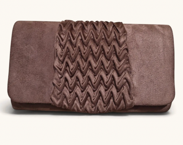 A brown suede clutch bag featuring a central chevron-patterned flap, photographed against a clean off-white background.