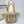 Load image into Gallery viewer, Woven handbag with beige handles on a white surface
