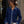 Load image into Gallery viewer, Front view of a woman wearing a navy blue fine-knit button-up cardigan featuring a contrast light-wash denim collar, placket, and layered cuffs, finished with polished gold dome buttons and styled with white pants
